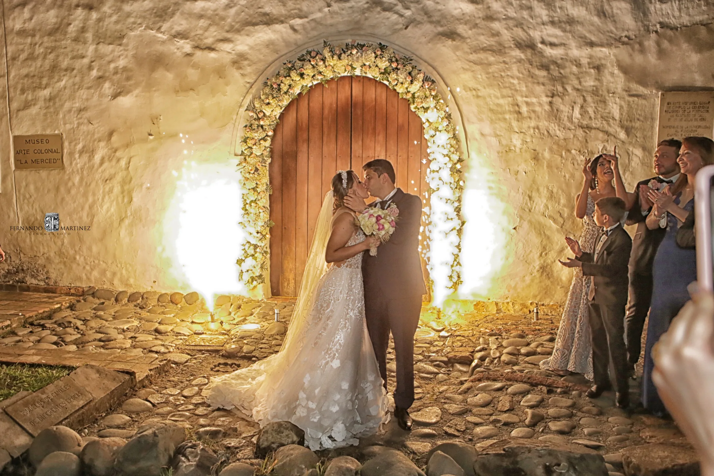 Couple kissing under colonial arch
