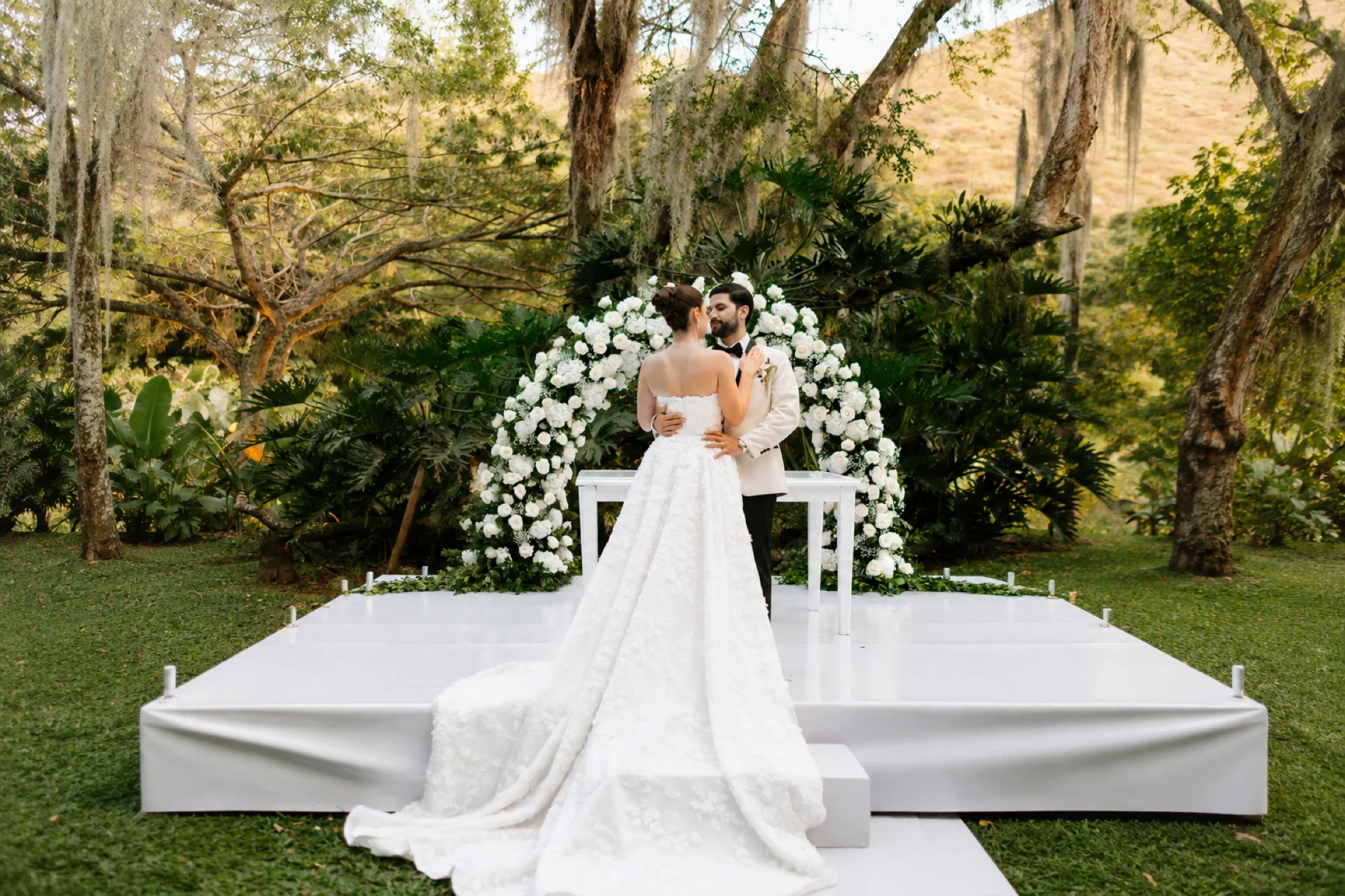 Outdoor wedding ceremony with white chairs